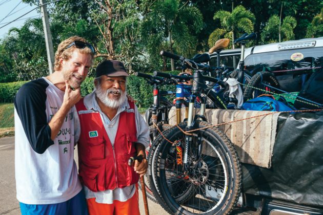 Andrew Whiteford explains how our bikes work to a local farmer along the road to Doi Bakia in the jungle near Chiang Dao, Thailand.