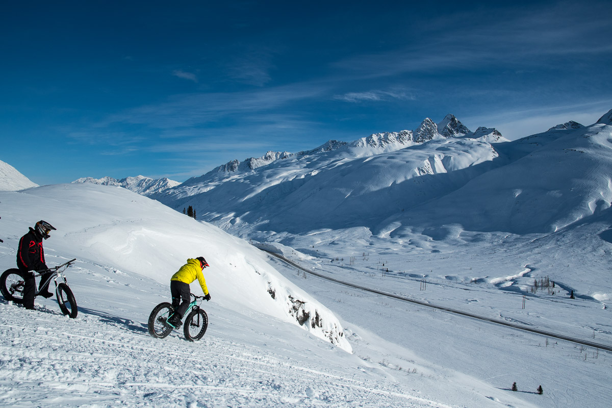 Day one on Thompson Pass - Russ Risdon/FatBack Bikes in black jacket, Andrew Taylor/Norco Bikes in yellow. Photo: Eddie Clark 